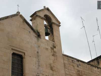 Nel prospetto � inglobato sulla destra un basso campanile a vela...